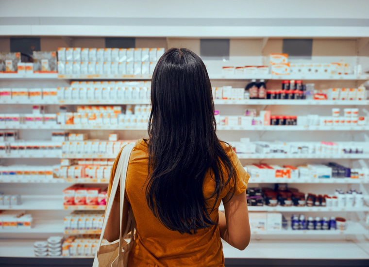 Woman looking at the pharmaceutical drugs.