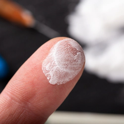 Cocaine on a finger closeup