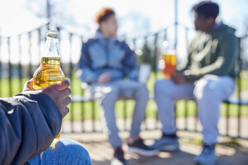 Teenagers drinking alcohol in a park
