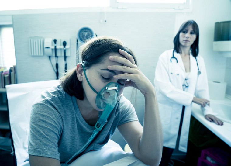 Woman wearing oxygen mask in a hospital, inhalants abuse