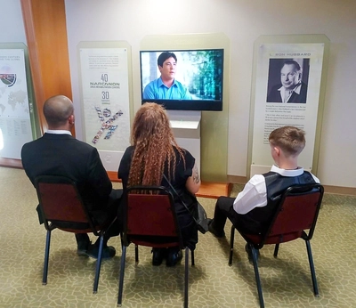 Narconon Arrowhead Community Open House, guests watching Narconon graduate success storries 