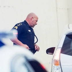 Police officer is checking a car