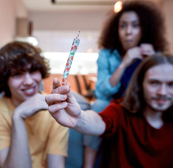 Teenagers are looking at marijuana joint in a fancy packaging