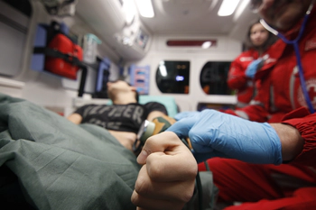 Paramedics checking pulse