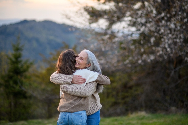 Grandmother hugs granddaughter