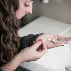 Girl holding pills