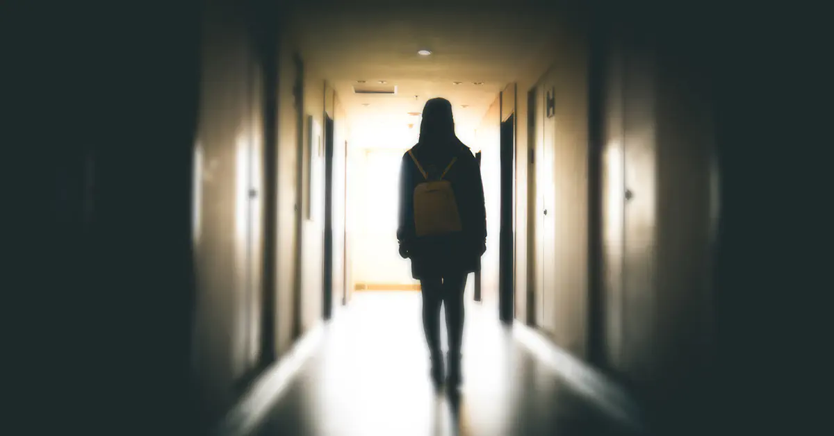 Teenager walking in hallway
